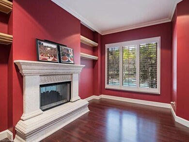 Den with Fireplace and Wood Floors