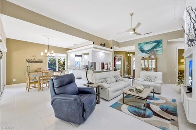 Tiled living room with sink, crown molding, and ce