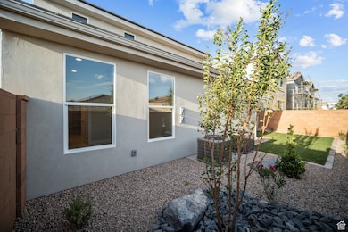 View of home's exterior with stucco siding and a central air condition unit