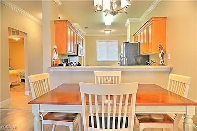 Dining area with a chandelier and crown molding