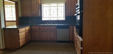 Large kitchen area with beautiful wood cabinets.