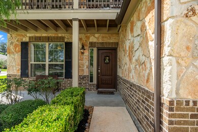 Lovely front porch with stone and brick exterior,