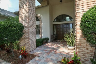 The home's entrance boasts stone paved walkway and