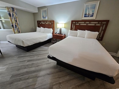 Bedroom with baseboards and wood finished floors