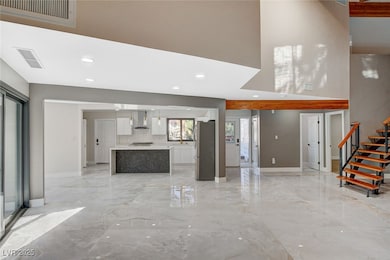Unfurnished living room featuring light marble fin