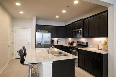 Kitchen featuring stainless steel appliances, lig