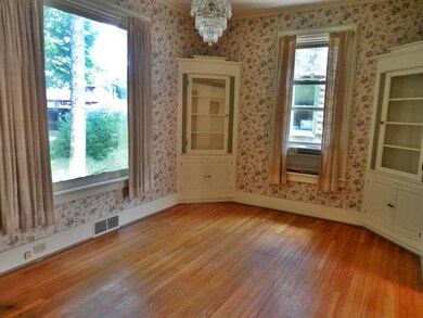 Dining room has built-in corner cabinets