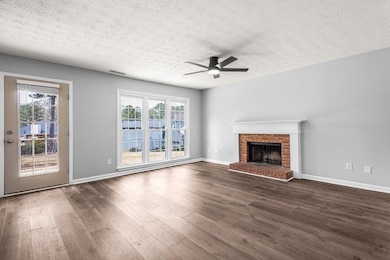 Unfurnished living room with ceiling fan, baseboar