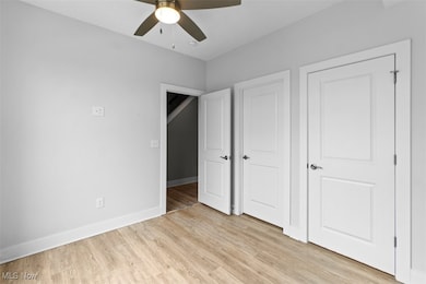 Unfurnished bedroom featuring light wood finished floors and ceiling fan