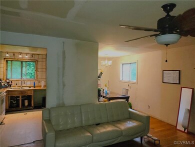 Living room featuring ceiling fan with notable cha