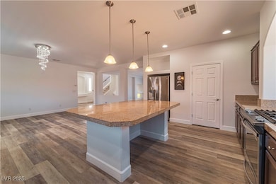 Kitchen with stainless steel appliances, a center