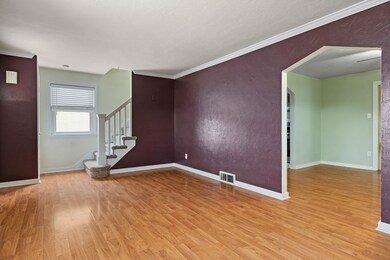 Living Room. This photo captures access to the dining room and stairway. Nice flow!