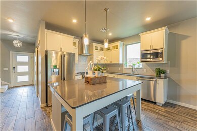 Kitchen with large center island, custom lighting,