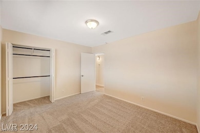 Unfurnished bedroom with light colored carpet and