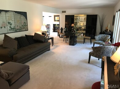 Spacious Living room. Note Hardwood floor under ca