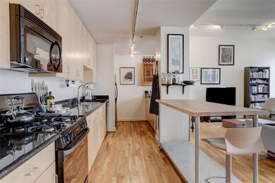 Kitchen is spacious with lightly stained cabinets,