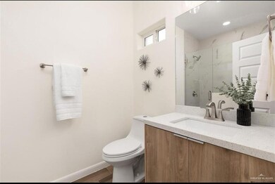 Full bath with visible vents, toilet, vanity, and bath / shower combo with glass door