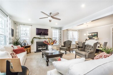 Family room with ceiling fan and gas fireplace.