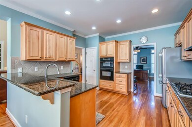 The kitchen has plenty of cabinets, lovely granite