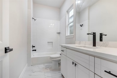 The first floor bathroom features a combo tub and