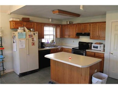 A generous sized kitchen with an island and pantry