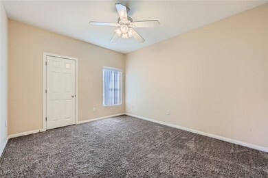 Unfurnished room with carpet, a ceiling fan, and b