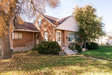 View of front of house featuring brick siding and roof with shingles
