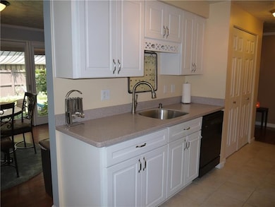 Kitchen has abundance of cabinets and pantry.