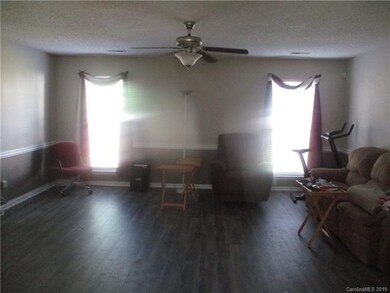Large great room with newer laminate wood floors a