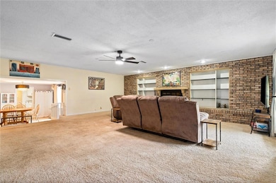 Living area featuring a built in shelves and firep