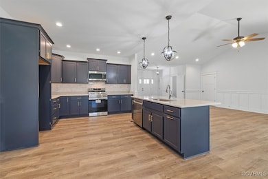 Kitchen featuring light countertops, a sink, light