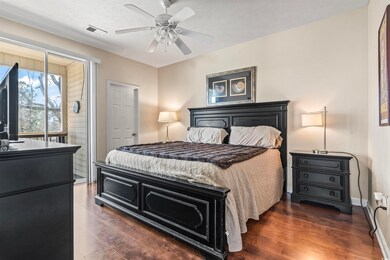 Bedroom with baseboards, ceiling fan, wood finishe