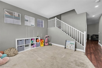 Recreation room with carpet and baseboards
