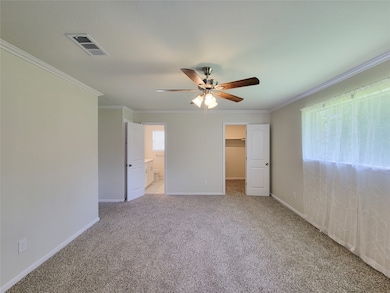 spacious primary bedroom with large walk in closet