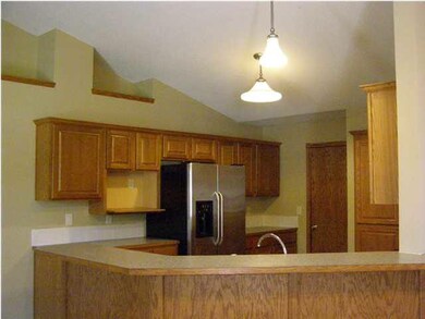 Kitchen with bar area and stainless steel refriger