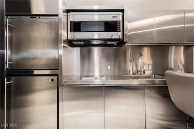 Kitchen featuring a sink, modern cabinets, stainle