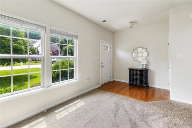 Foyer with carpet and baseboards