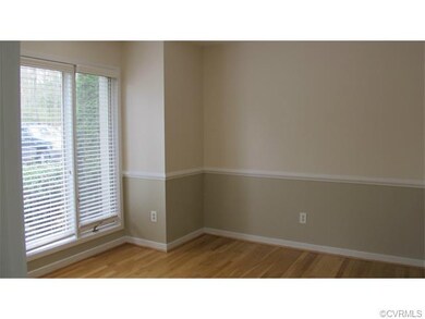 Eat in kitchen area with hardwood floors and skyli
