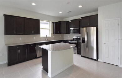 Designer Kitchen with Built-In Island and Stainless Steel Appliances