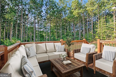 Outdoors, enjoy a Large Deck designed for Al Fresco Dining, overlooking a Huge, Private Backyard framed by Mature Trees ideal for Relaxation, Play, or Entertaining.