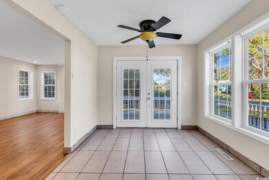 Doorway to outside with ceiling fan, light tile pa