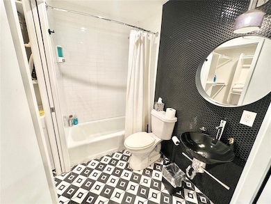 Full bath with shower / bath combination with curtain and a sink