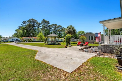 View of yard with a gazebo and concrete driveway