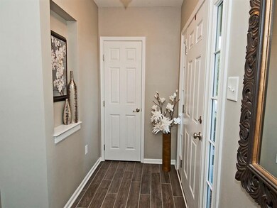 Entrance foyer is upgraded with newer wood-tile fl