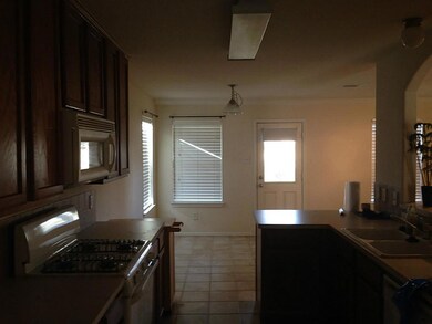 Kitchen overlooks family room and is attached to the formal dining