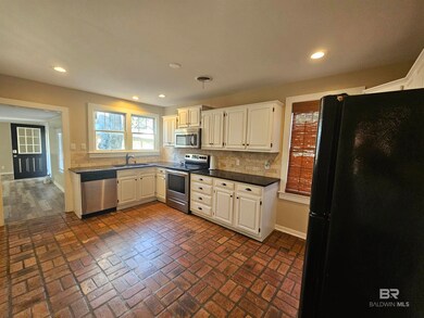 backsplash, sink, and dark stone countertops