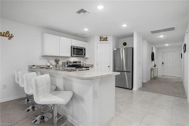 Kitchen with light countertops, visible vents, a p