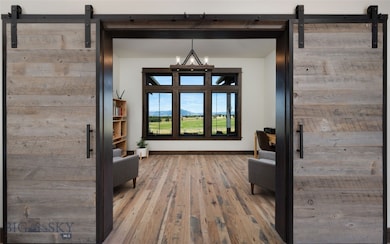 Foyer opens to office with custom doors and big vi