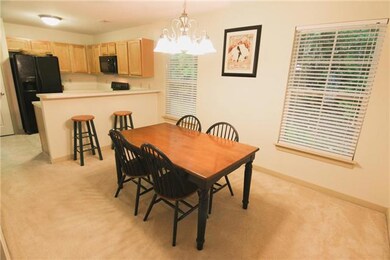 Dining room area with stylish brushed nickel frosted glass chandelier. Energy efficient insulated tilt-in windows throughout the home.