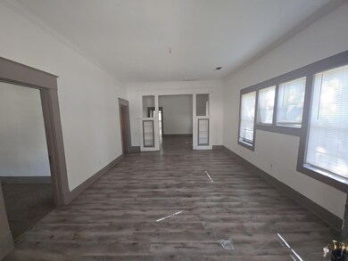 Unfurnished living room with ornamental molding an